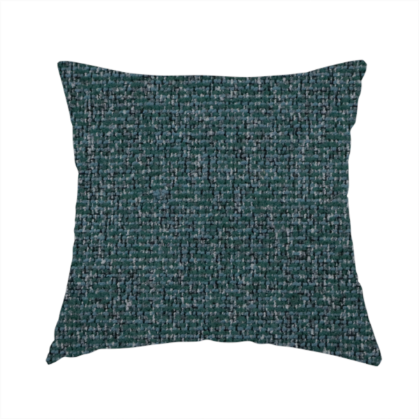 The fabric used to create this handmade cushion is a multi-tonal deep teal and grey textured woven fabric swatch.