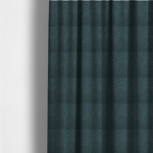 The fabric used to create these made-to-measure curtains is a multi-tonal deep teal and grey textured woven fabric swatch.