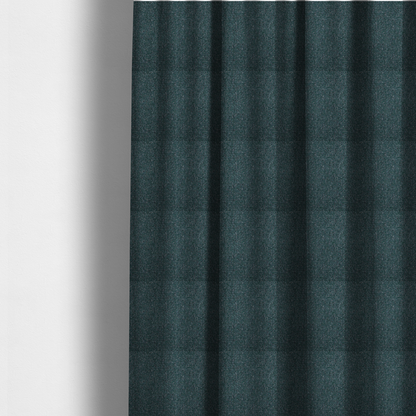 The fabric used to create these made-to-measure curtains is a multi-tonal deep teal and grey textured woven fabric swatch.