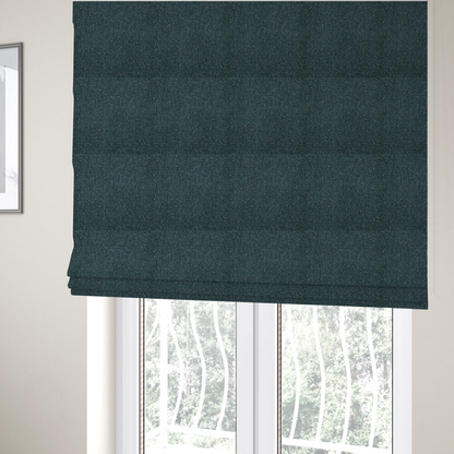 The fabric used to create these Roman blinds is a multi-tonal deep teal and grey textured woven fabric swatch.