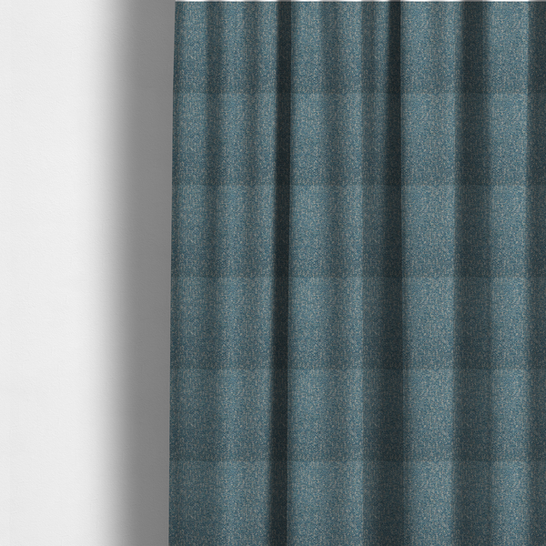 The fabric used to create these made-to-measure curtains is a multi-tonal blue and beige textured woven fabric swatch.