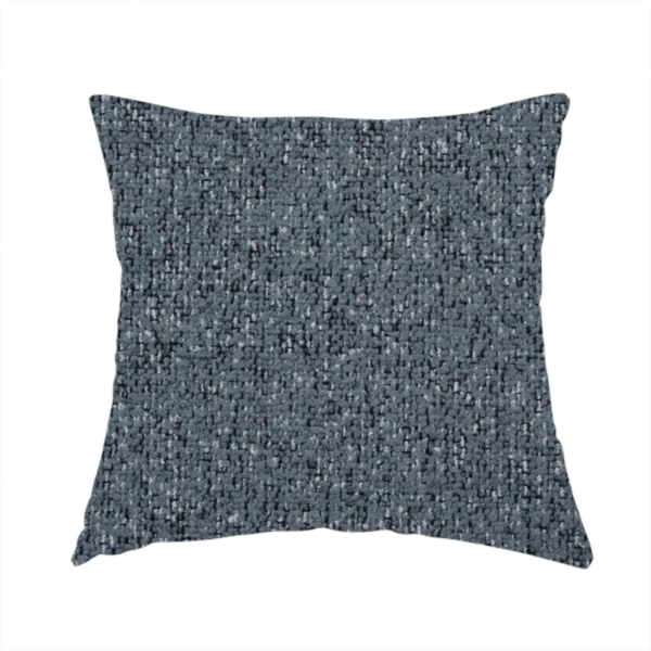 The fabric used to create this handmade cushion is a multi-tonal slate blue and grey textured woven fabric swatch.