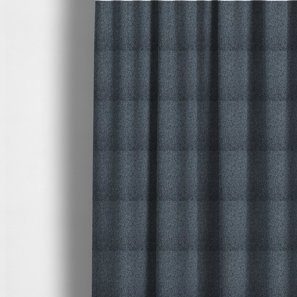 The fabric used to create these made-to-measure curtains is a multi-tonal slate blue and grey textured woven fabric swatch.