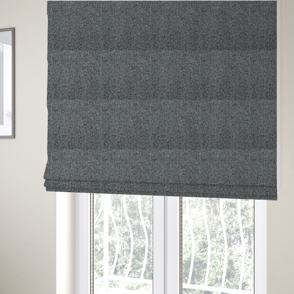 The fabric used to create these Roman blinds is a multi-tonal grey and charcoal textured woven fabric swatch.