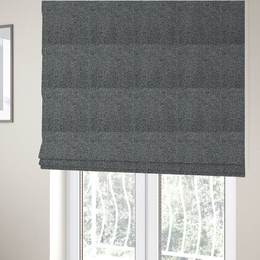 The fabric used to create these Roman blinds is a multi-tonal grey and charcoal textured woven fabric swatch.