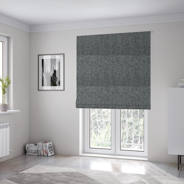 The fabric used to create these Roman blinds is a multi-tonal grey and charcoal textured woven fabric swatch.