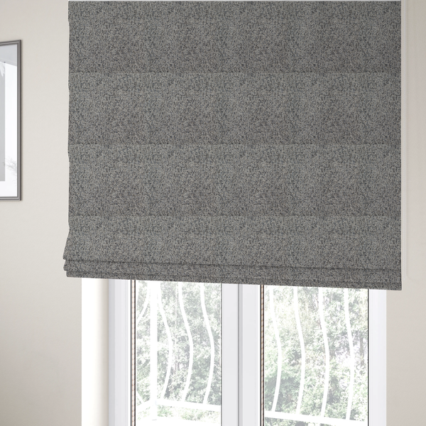 The fabric used to create these Roman blinds is a multi-tonal light grey and cream textured woven fabric swatch.