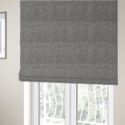 The fabric used to create these Roman blinds is a multi-tonal light grey and cream textured woven fabric swatch.