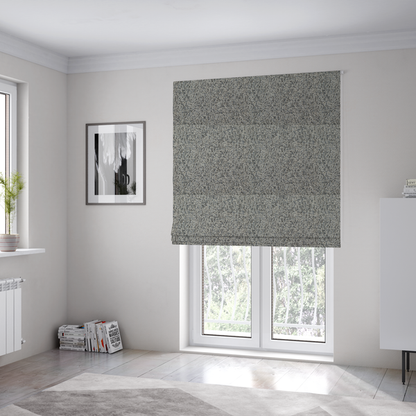 The fabric used to create these Roman blinds is a multi-tonal light grey and cream textured woven fabric swatch.