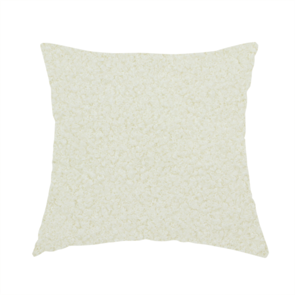 The fabric used to create this handmade cushion is a textured cream-coloured bouclé upholstery fabric.