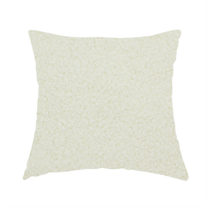 The fabric used to create this handmade cushion is a textured cream-coloured bouclé upholstery fabric.