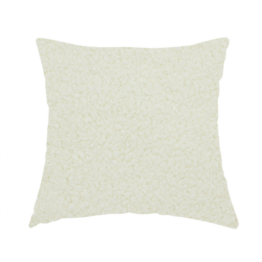 The fabric used to create this handmade cushion is a textured cream-coloured bouclé upholstery fabric.
