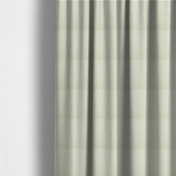 The fabric used to create these made-to-measure curtains is a textured cream-coloured bouclé upholstery fabric.