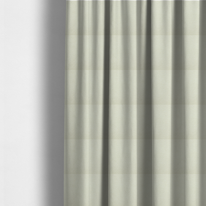 The fabric used to create these made-to-measure curtains is a textured cream-coloured bouclé upholstery fabric.