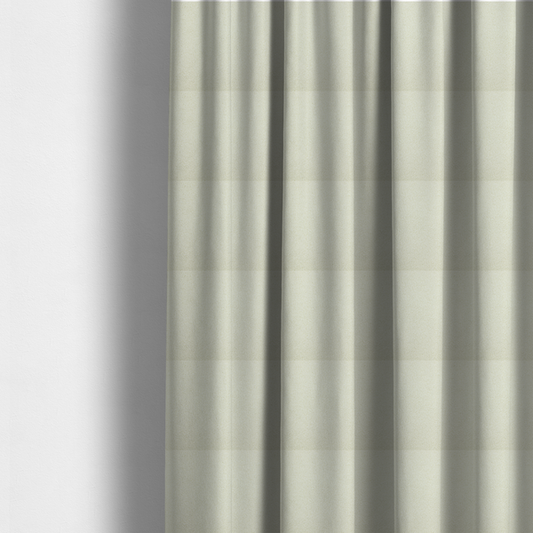 The fabric used to create these made-to-measure curtains is a textured cream-coloured bouclé upholstery fabric.
