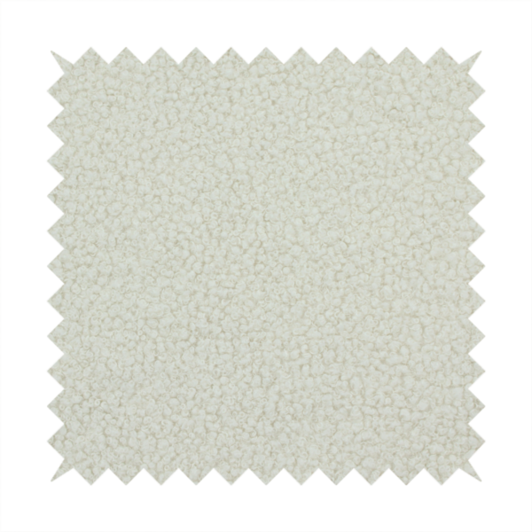 A textured beige or oatmeal bouclé upholstery fabric.