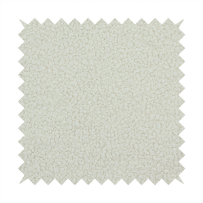 A textured beige or oatmeal bouclé upholstery fabric.