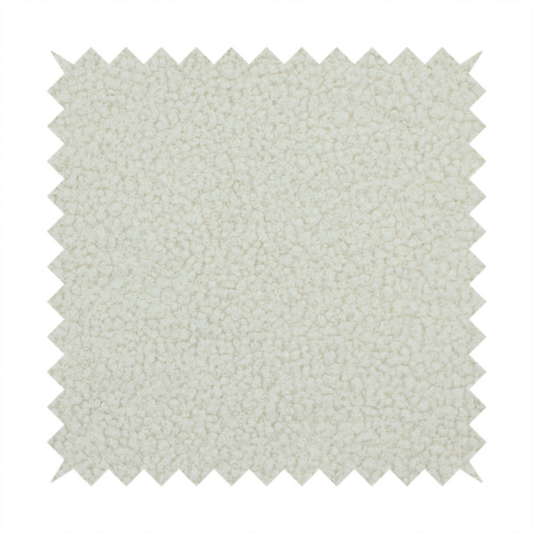A textured beige or oatmeal bouclé upholstery fabric.