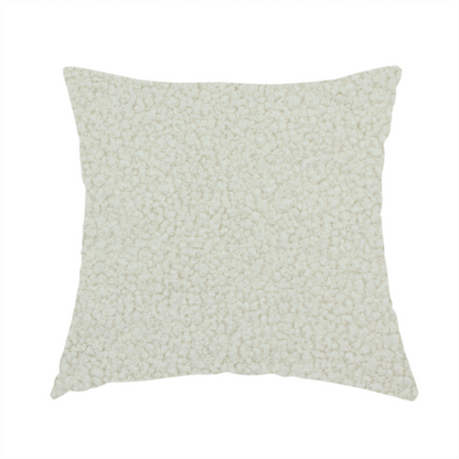The fabric used to create this handmade cushion is a textured beige or oatmeal bouclé upholstery fabric.