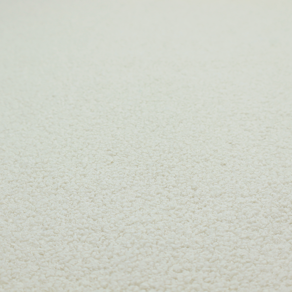 A textured beige or oatmeal bouclé upholstery fabric.