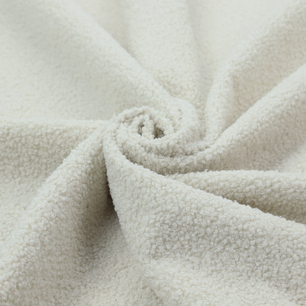 A textured beige or oatmeal bouclé upholstery fabric.