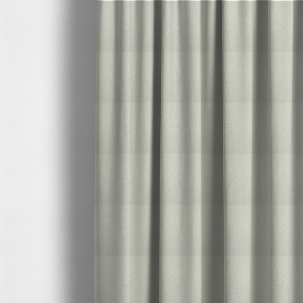 The fabric used to create these made-to-measure curtains is a textured beige or oatmeal bouclé upholstery fabric.