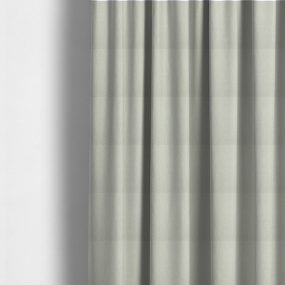 The fabric used to create these made-to-measure curtains is a textured beige or oatmeal bouclé upholstery fabric.