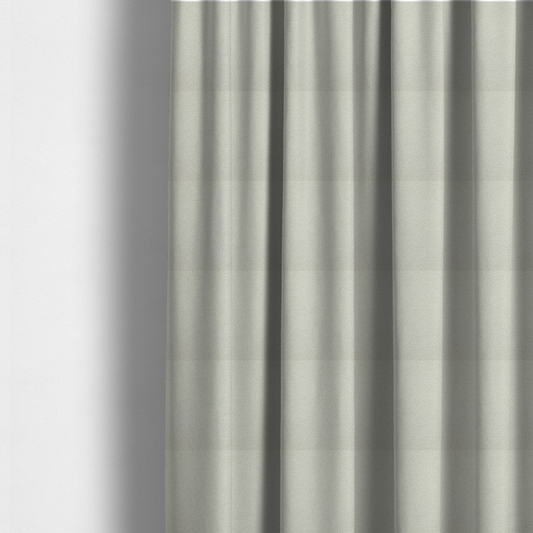 The fabric used to create these made-to-measure curtains is a textured beige or oatmeal bouclé upholstery fabric.