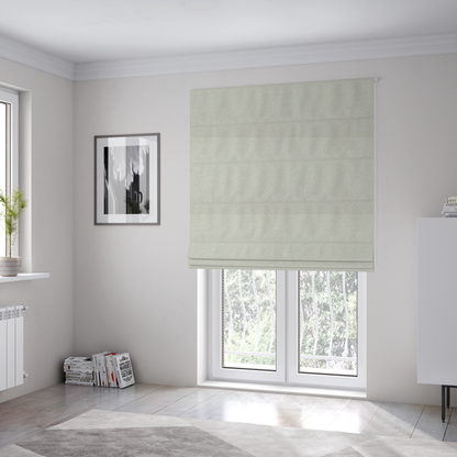 The fabric used to create these Roman blinds is a textured beige or oatmeal bouclé upholstery fabric.