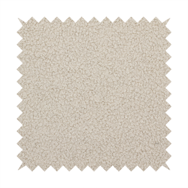 A textured beige bouclé upholstery fabric.