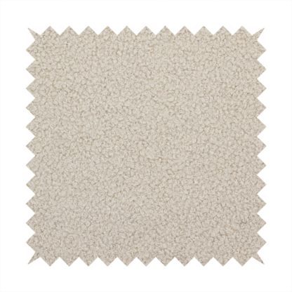 A textured beige bouclé upholstery fabric.
