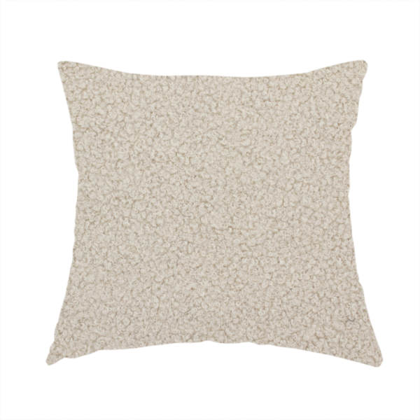 The fabric used to create this handmade cushion is a textured beige bouclé upholstery fabric.