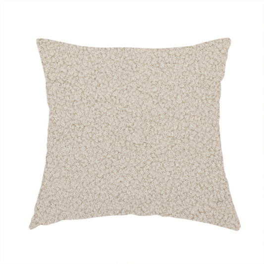 The fabric used to create this handmade cushion is a textured beige bouclé upholstery fabric.