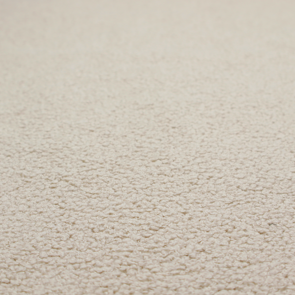 A textured beige bouclé upholstery fabric.