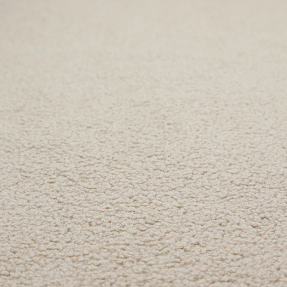 A textured beige bouclé upholstery fabric.