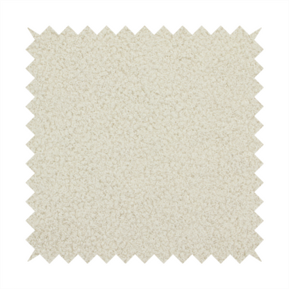 A textured ivory or light cream bouclé upholstery fabric.