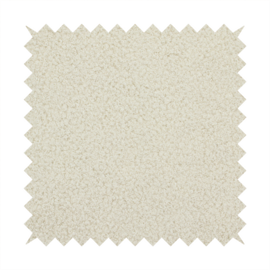 A textured ivory or light cream bouclé upholstery fabric.