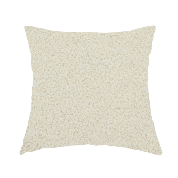 The fabric used to create this handmade cushion is a textured ivory or light cream bouclé upholstery fabric.