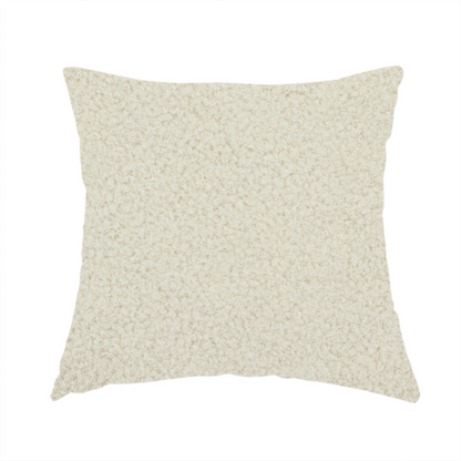 The fabric used to create this handmade cushion is a textured ivory or light cream bouclé upholstery fabric.