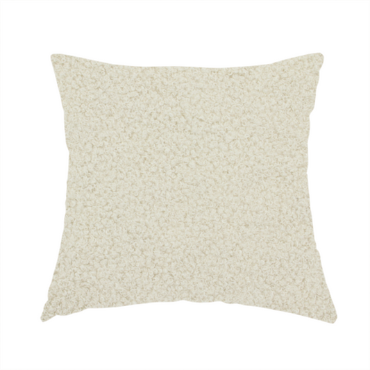 The fabric used to create this handmade cushion is a textured ivory or light cream bouclé upholstery fabric.