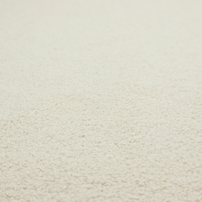 A textured ivory or light cream bouclé upholstery fabric.