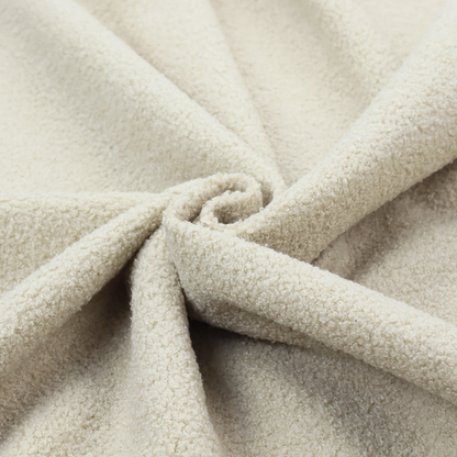 A textured ivory or light cream bouclé upholstery fabric.
