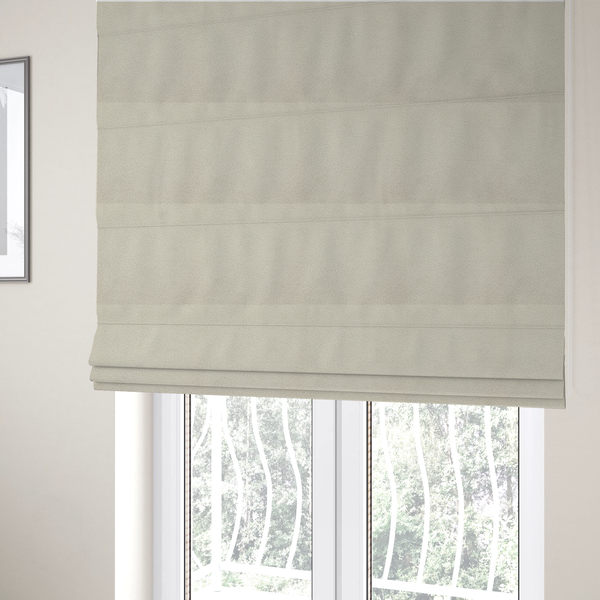 The fabric used to create these Roman blinds is a textured ivory or light cream bouclé upholstery fabric.