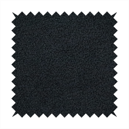 A textured charcoal black bouclé upholstery fabric.