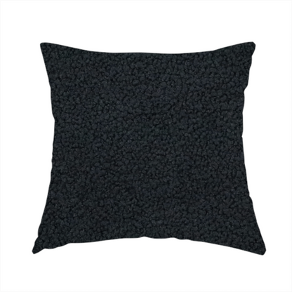 The fabric used to create this handmade cushion is a textured charcoal black bouclé upholstery fabric.