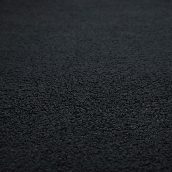 A textured charcoal black bouclé upholstery fabric.