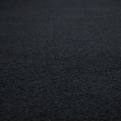 A textured charcoal black bouclé upholstery fabric.