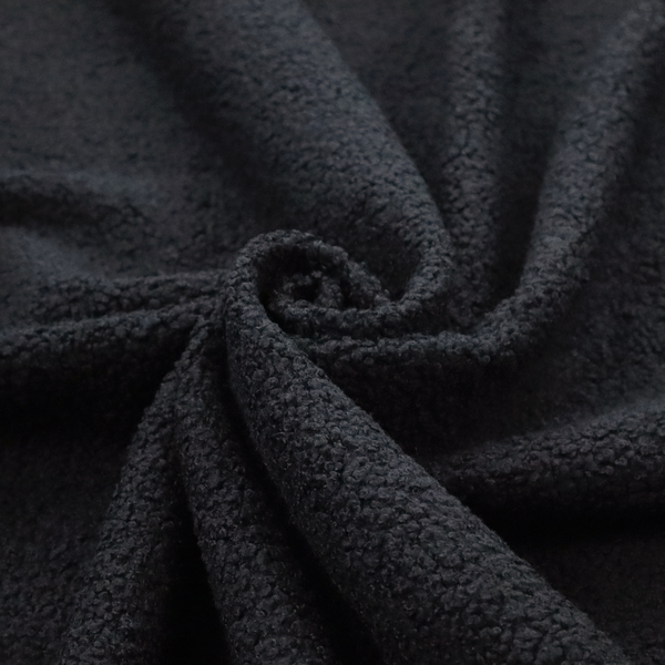 A textured charcoal black bouclé upholstery fabric.