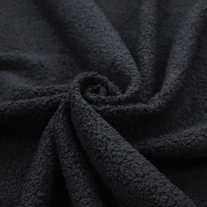 A textured charcoal black bouclé upholstery fabric.