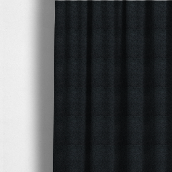 The fabric used to create these made-to-measure curtains is a textured charcoal black bouclé upholstery fabric.